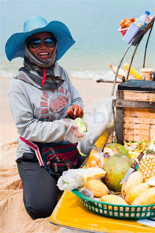 KOH SAMUI, THAILAND - MARCH 04: Thai woman selling traditional food at beach on March 04, 2013 at Samui island, Thailand. Street food cooking and selling is a local tradition, popular among tourists, stock photo
