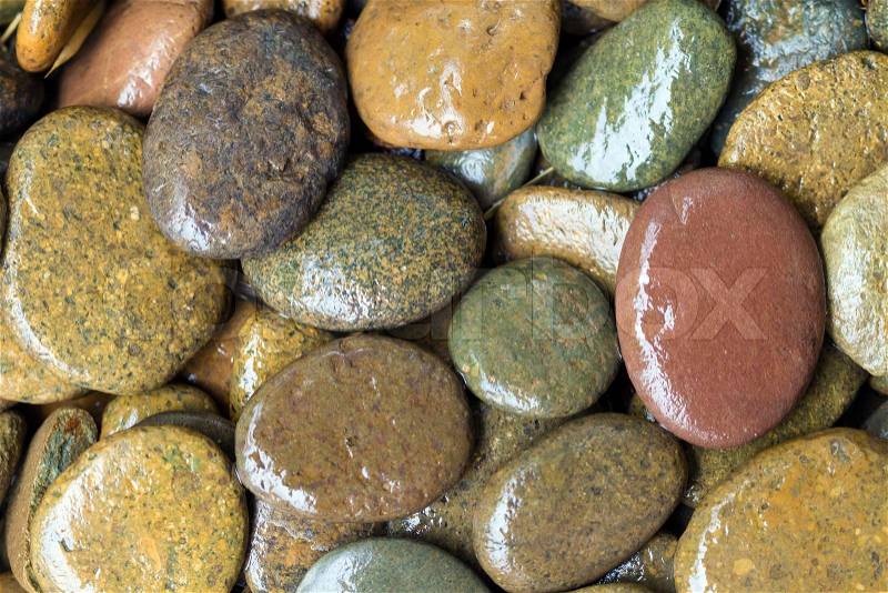 Round wet colored stones background near river, stock photo