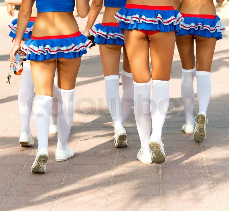 Group of young cheerleaders walking on a street, stock photo