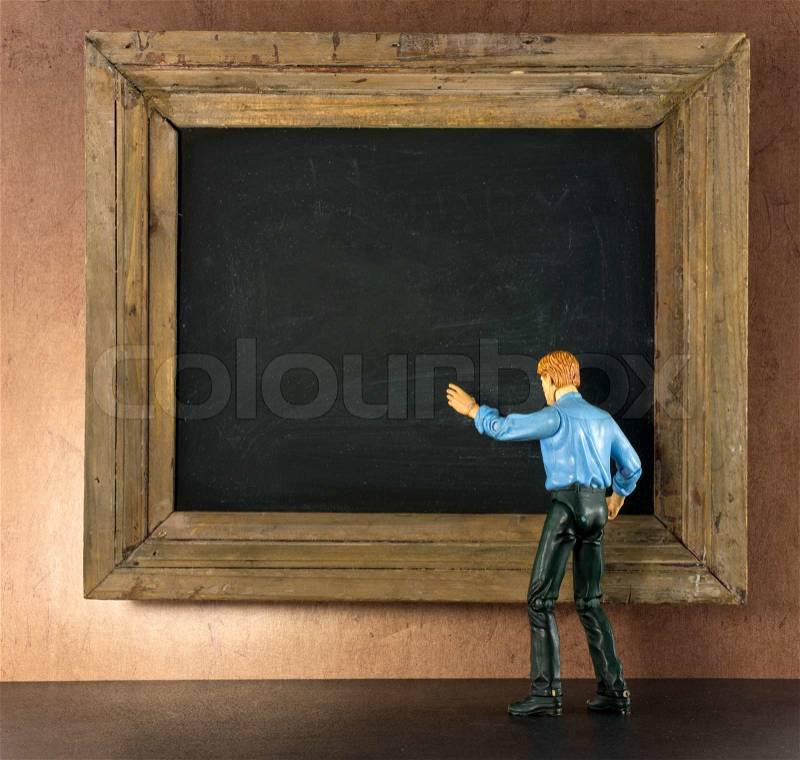 Business person against the blackboard with brown grunge wallpaper, stock photo
