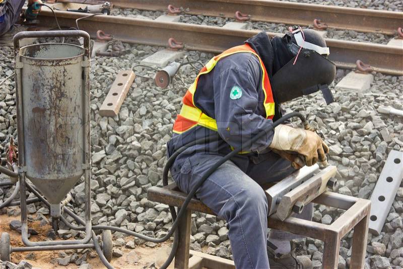 Workers repair the railway tracks with Sandblasted, stock photo