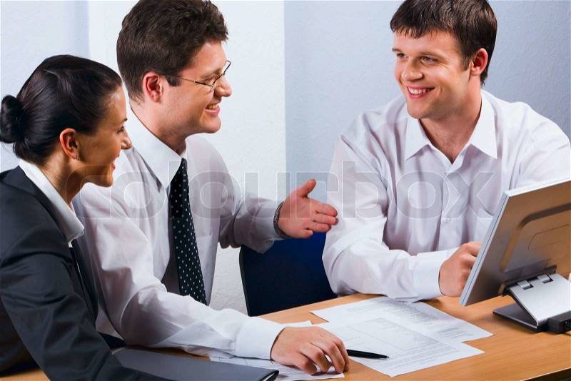 Business people talking at the workplace, stock photo