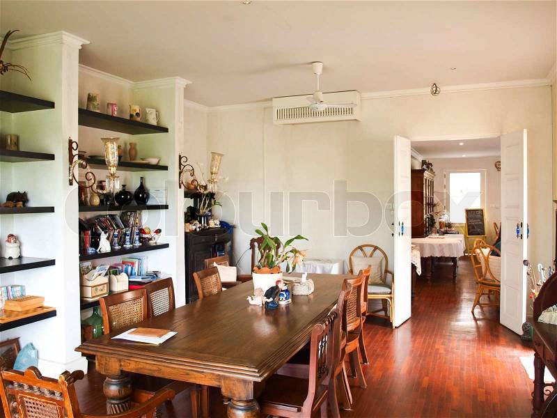 Dining room interior with classic brown furniture and natural light, stock photo