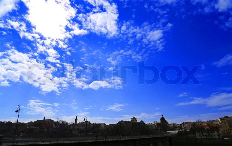 Blue sky with clouds silhouette of city, stock photo