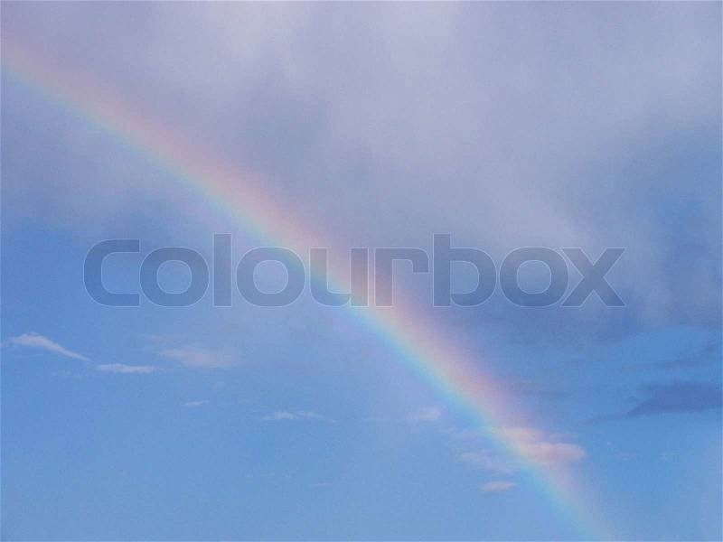 Rainbow in a cloudy sky, stock photo