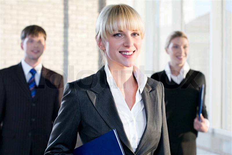 Portrait of female leader on the background of business people, stock photo