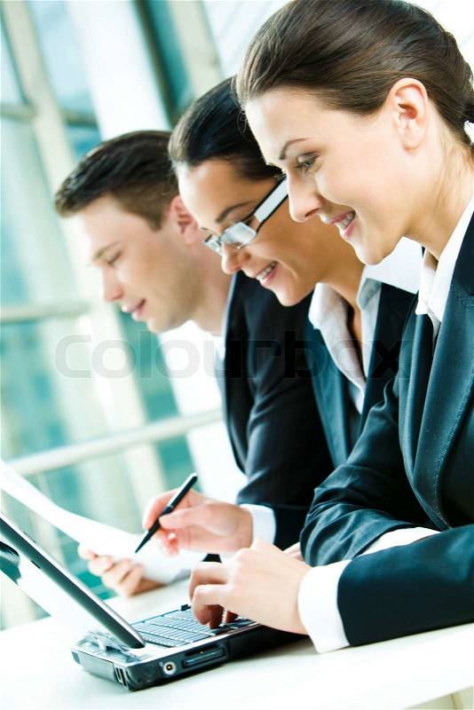 Row of business group working at table, stock photo