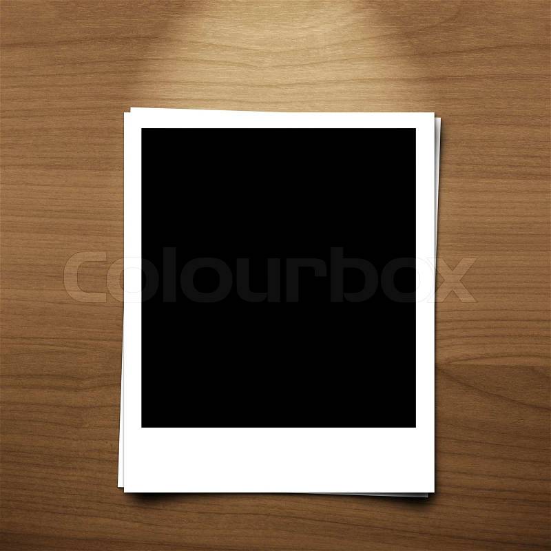 Blank photo frame on brown wood background with lighting lamp, stock photo