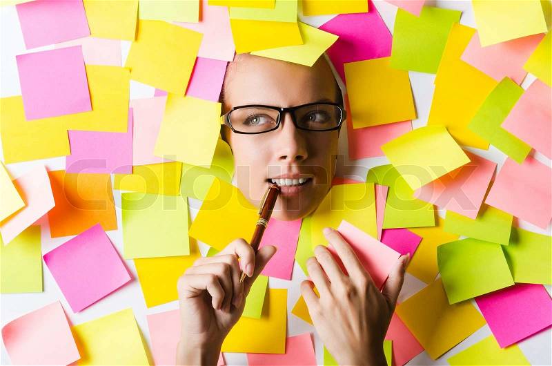 Businesswoman with lots of reminder notes, stock photo