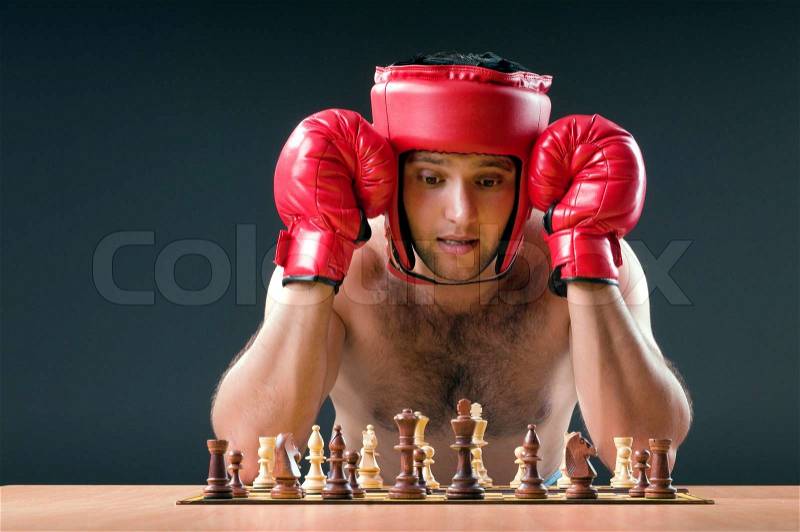 Boxer stuggling with chess game, stock photo