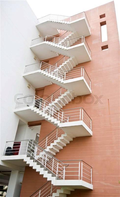 Z shaped fire escape leading down back of building, stock photo
