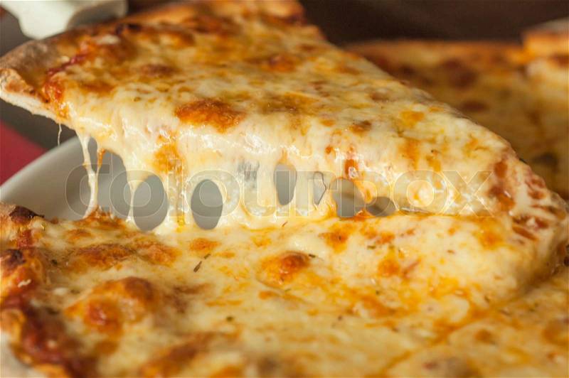 Slice of pizza margarita lifted up, stock photo