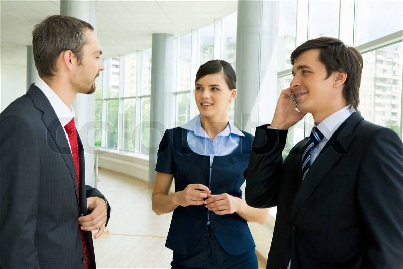 Photo of successful business partners consulting each other or sharing their ideas, stock photo