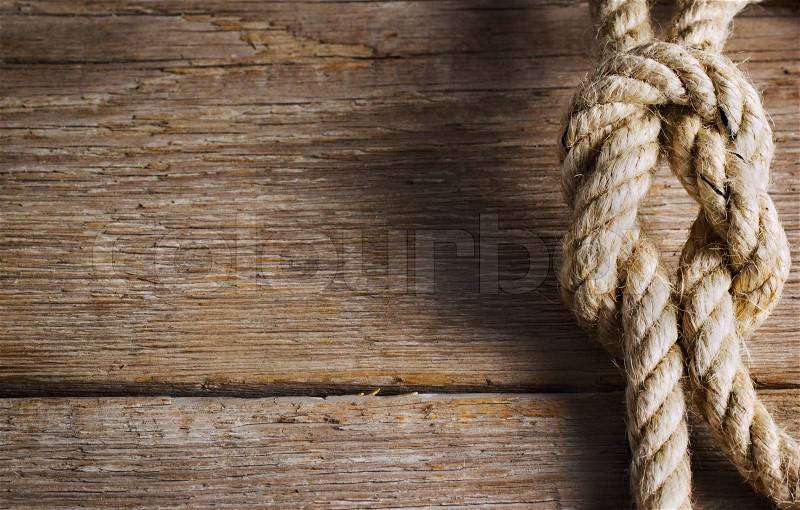 Old wood with rope knot, stock photo