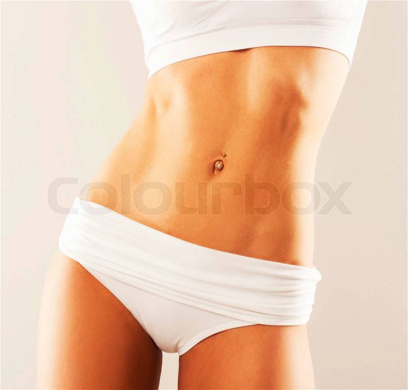 Slim tanned woman\'s body. perfect belly, stock photo