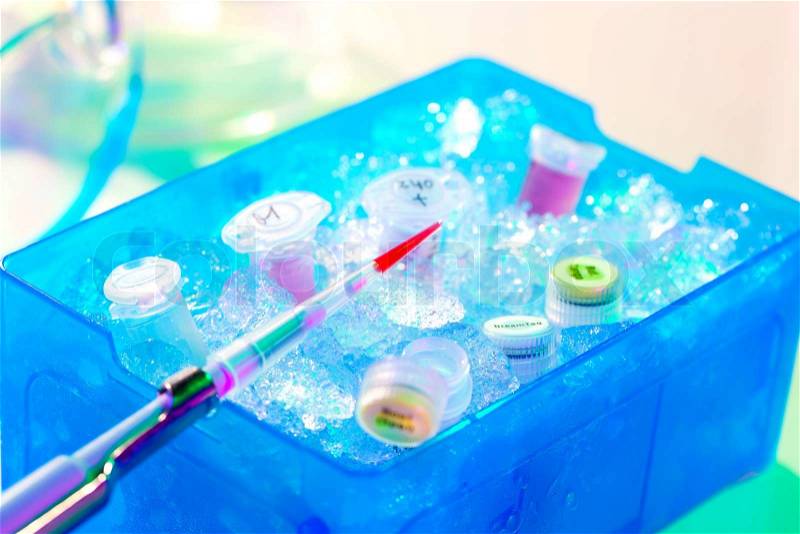 Automatic pipette over reaction tube in a box full of ice, stock photo