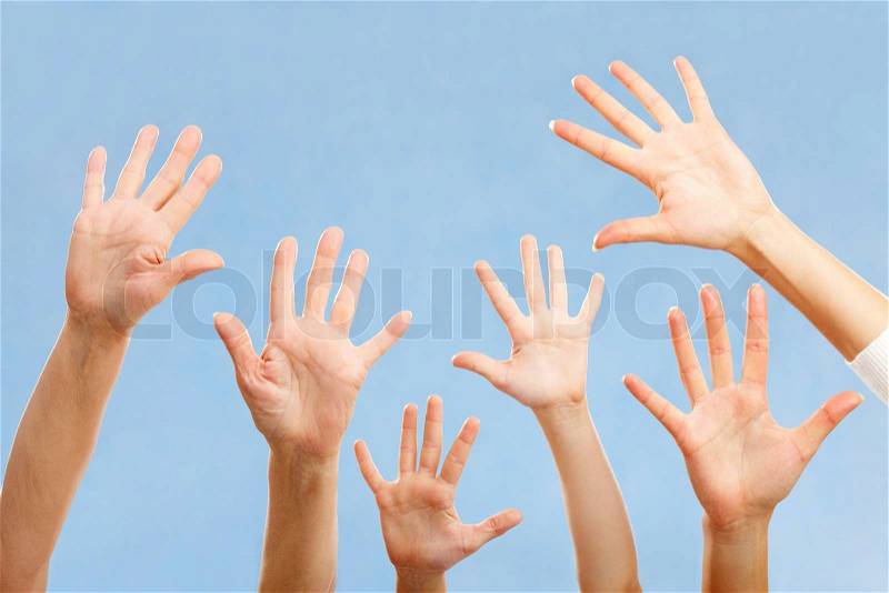 Image of hands raising isolated on blue background, stock photo