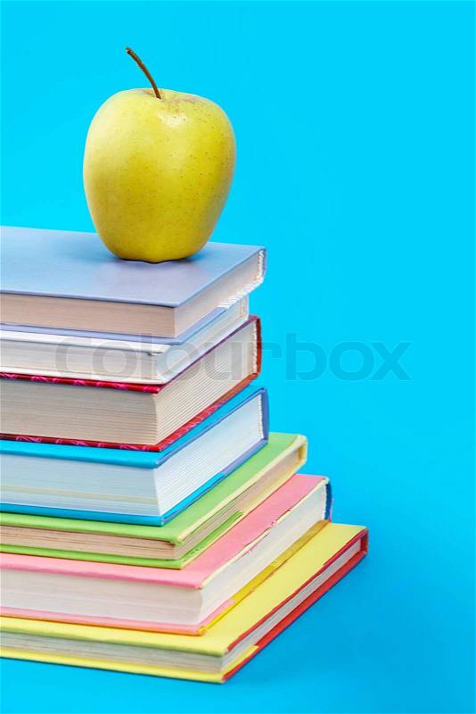 Vertical image of books with green apple , stock photo