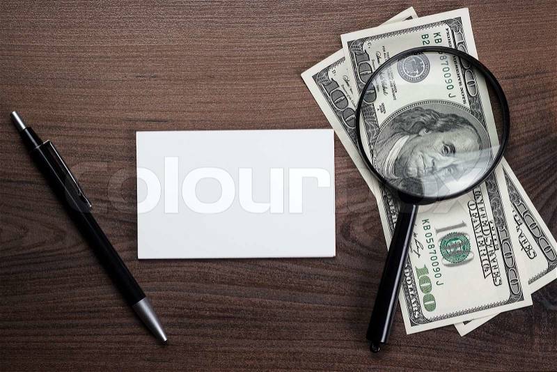 Blank notebook pen and money on the wooden table, stock photo