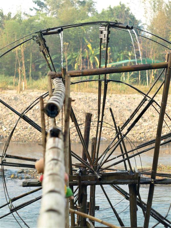 Bamboo water wheel. The use of water power for irrigation.Thailand , stock photo