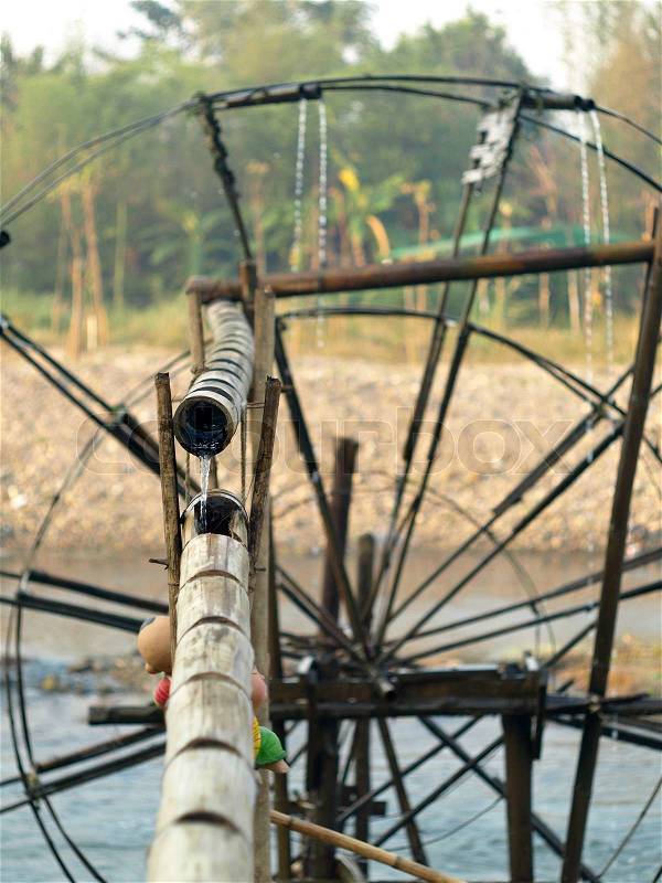 Bamboo water wheel. The use of water power for irrigation.Thailand , stock photo