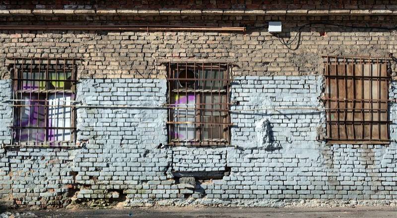 Old abandoned building wall texture with locked windows, stock photo
