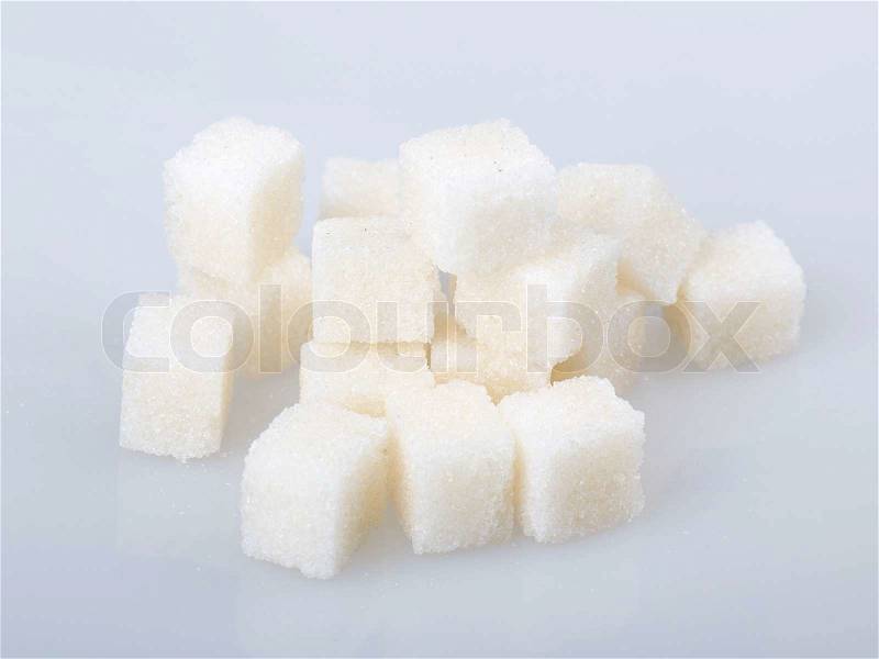 Sugar cubes on a gray background, stock photo