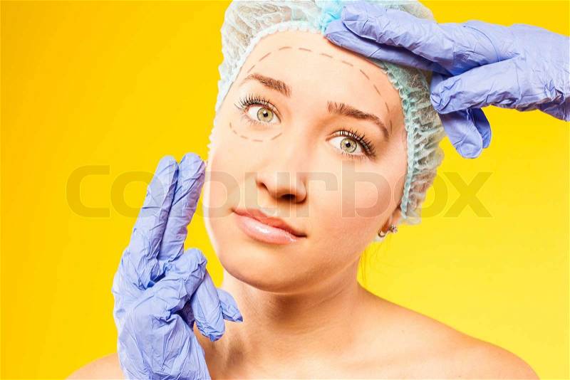 Woman with perforation lines on her face plastic surgery operation isoleted on white background, stock photo
