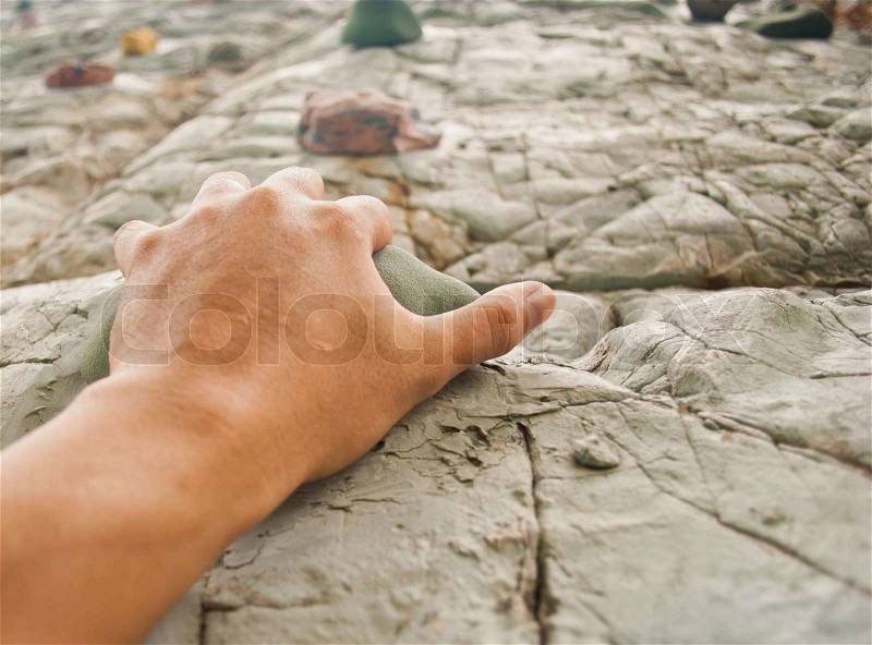 One hand to climb the cliff, stock photo