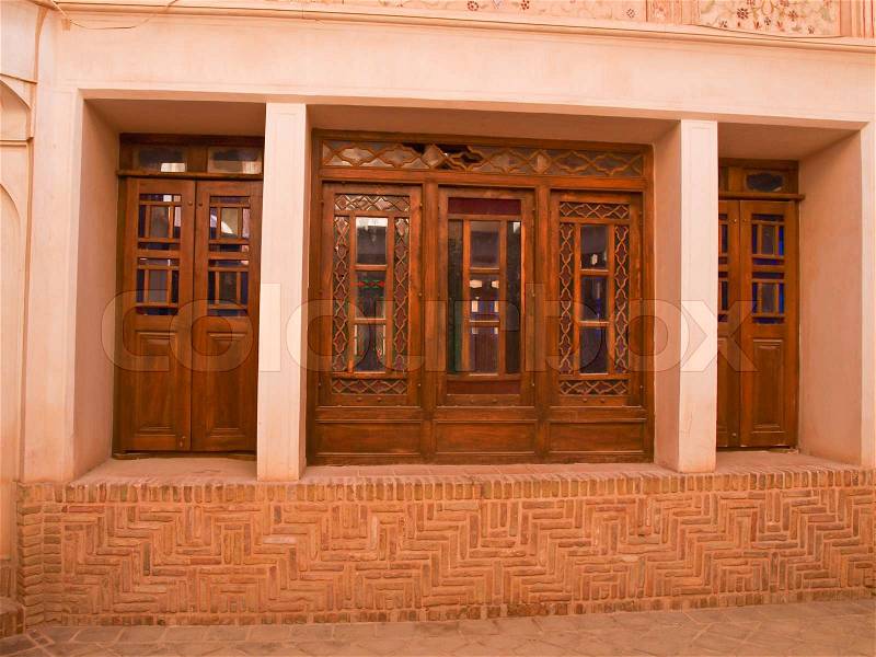The exterior of stain glass wooden doors in historic old house in Kashan, Iran, stock photo