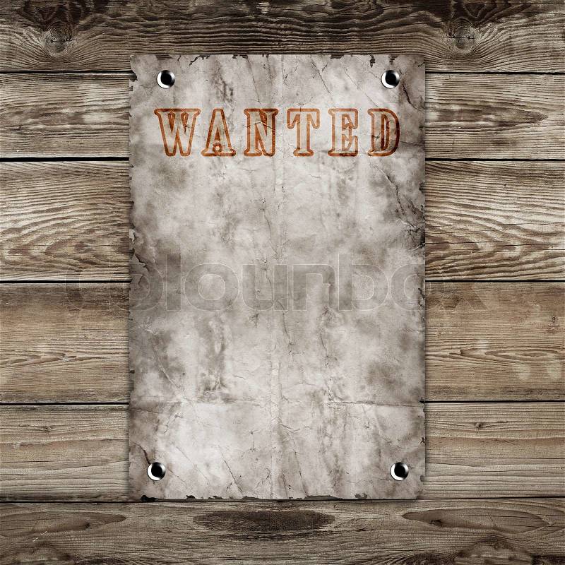 Old western wanted poster on wooden background, stock photo