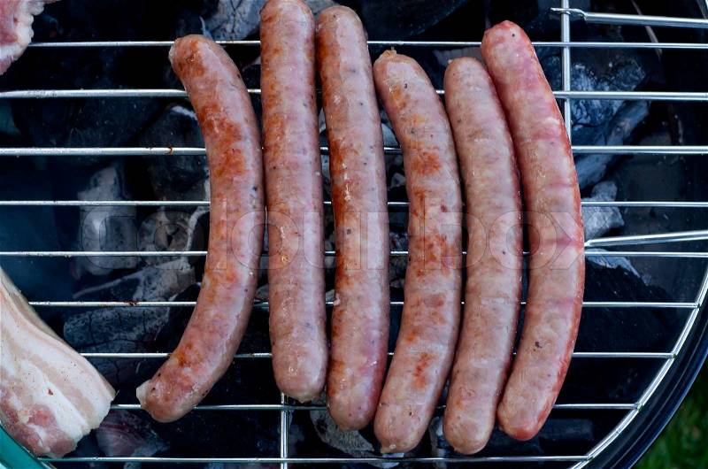 Sausages on grill closed-up, barbecue party, stock photo