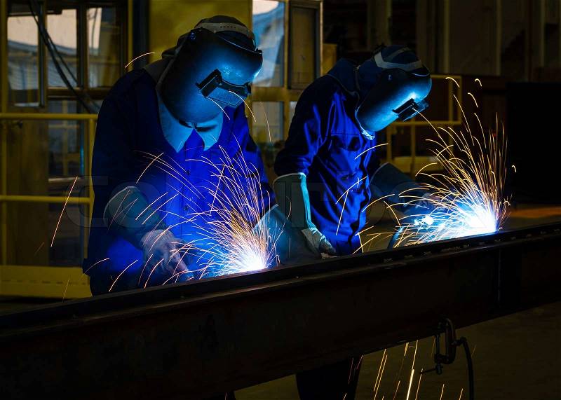 MIG welder uses torch to make sparks during manufacture of metal equipment. , stock photo