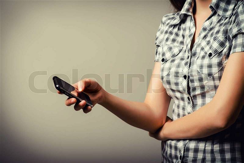 Mobile phone in the hands of a girl, stock photo