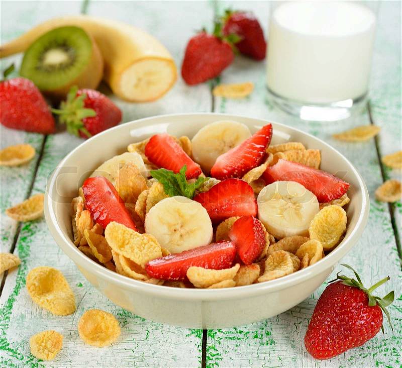 Cornflakes with fruits on a white table, stock photo