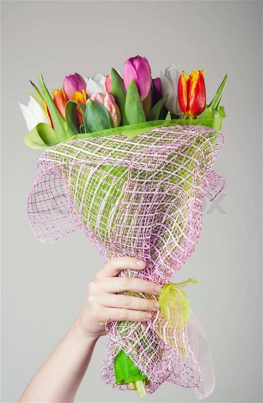 Woman holding tulip flowers, stock photo
