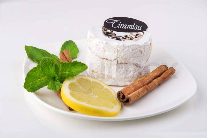 Tasty cake with mint and lemon on white background, stock photo