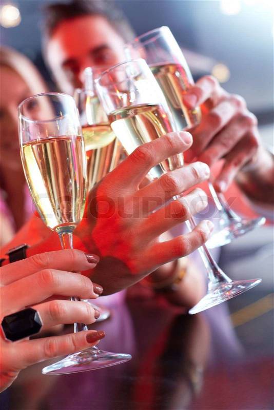 Image of friends hands holding crystal glasses full of champagne, stock photo