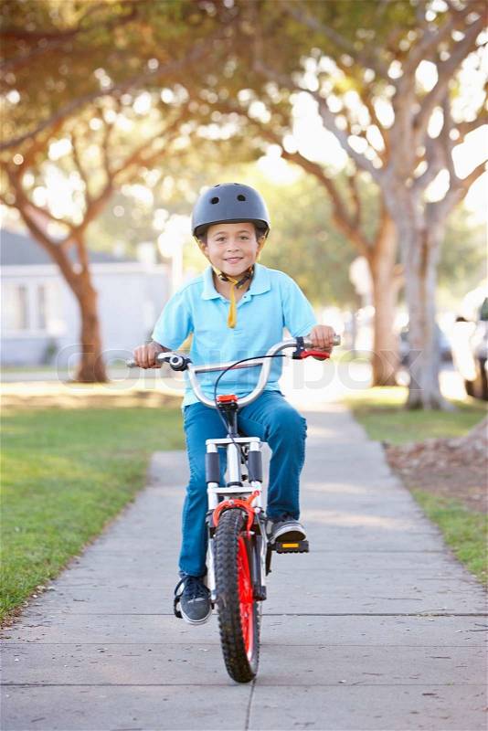 Boy Wearing Safety Helmet Riding Bike, stock photo