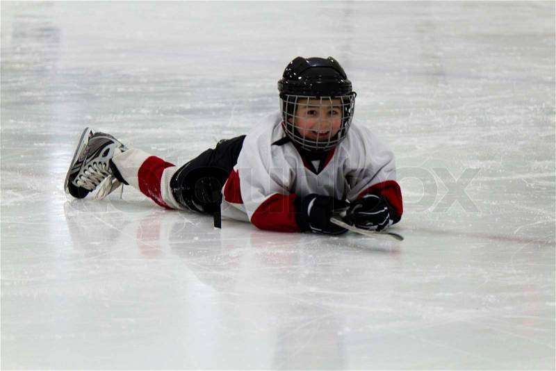 Child playing ice hockey, stock photo