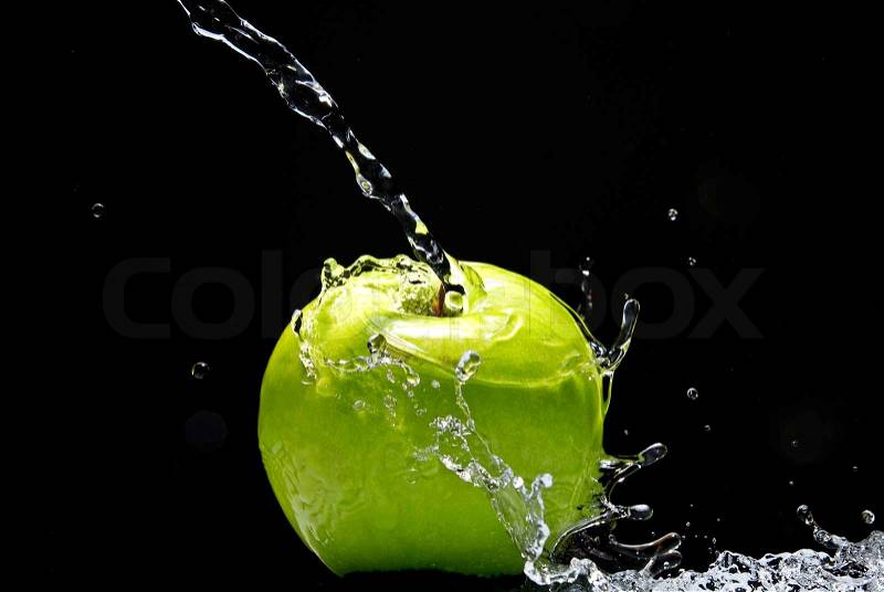 Green apple with water splash on black background, stock photo