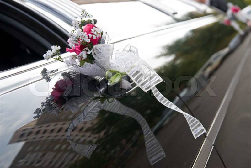 Door of black wedding car with flower and ribbon, stock photo