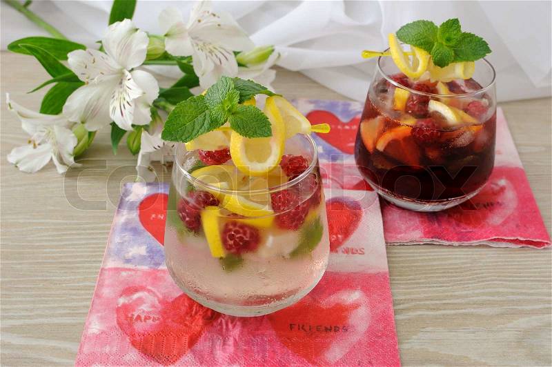 A glass of fresh homemade lemonade with mint and raspberries, stock photo