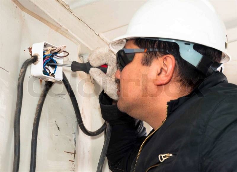 The electrician establishes an electrical wiring. Installation of equipment on production, stock photo