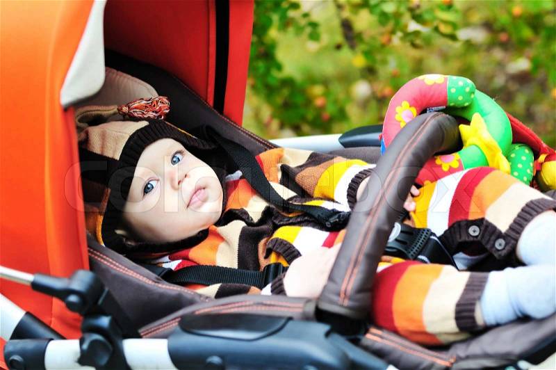 Baby laying in the stroller, stock photo