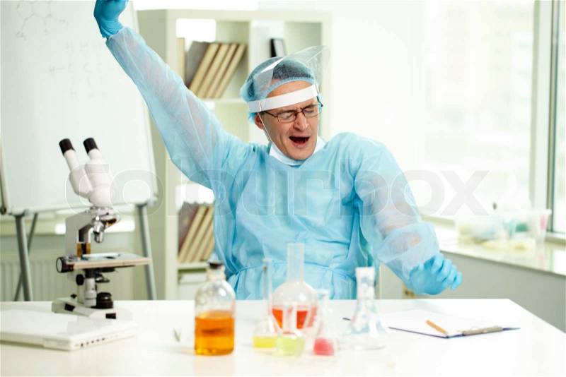 Sleepy clinician yawning during working day in lab , stock photo