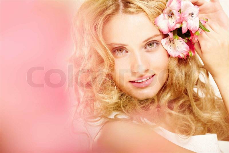 Charming blonde with fresh flowers in her hair, stock photo