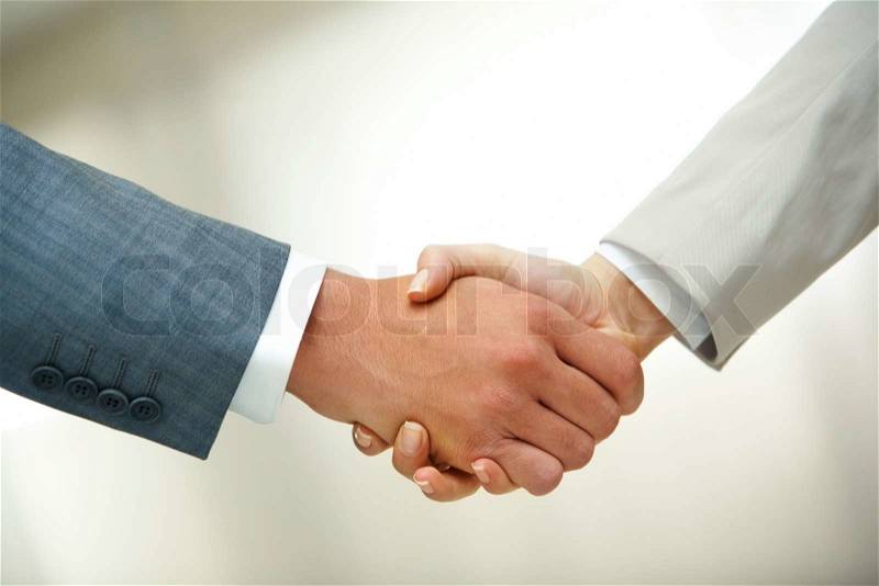 Photo of handshake of business partners after signing contract, stock photo