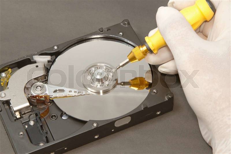 Hand with gloves repairs hard drive ,data recovery concept, stock photo