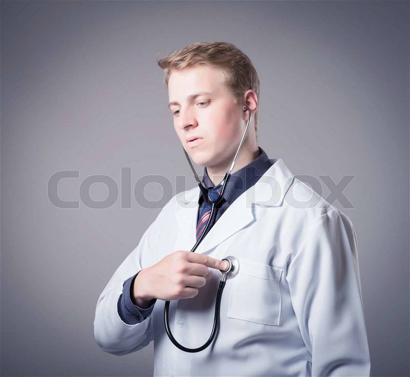 Young doctor measures the heart rate itself, stock photo